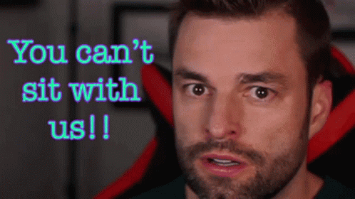 A Man With A Beard Is Sitting In A Red And Black Chair And Talking . GIF