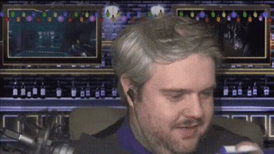 A Man With A Beard Is Sitting In Front Of A Screen That Says ' A ' On It GIF