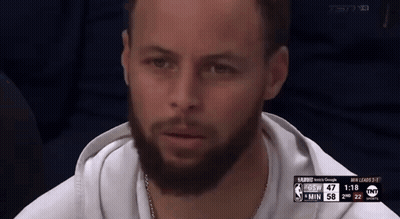 A Man With A Beard Is Sitting In Front Of A Screen That Says Tnt On It GIF