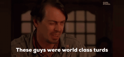 A Man With A Beard Is Sitting In Front Of A Window And Talking To Someone . GIF