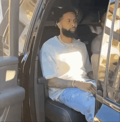 A Man With A Beard Is Sitting In The Back Of A Car GIF