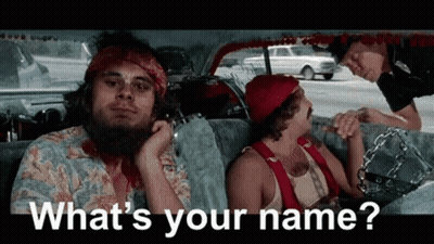 A Man With A Beard Is Sitting In The Back Seat Of A Car While A Police Officer Talks To Him . GIF