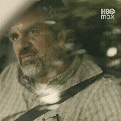 A Man With A Beard Is Sitting In The Back Seat Of A Car With A Hbo Max Logo Behind Him GIF