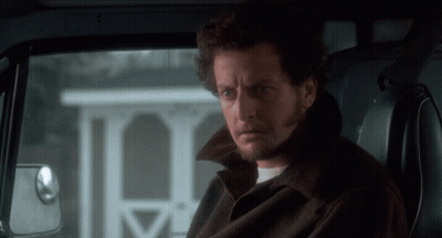 A Man With A Beard Is Sitting In The Back Seat Of A Vehicle GIF