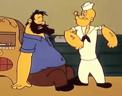 A Man With A Beard Is Sitting Next To A Man With A Sailor Hat GIF