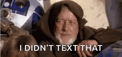 A Man With A Beard Is Sitting Next To A R2d2 Robot . GIF