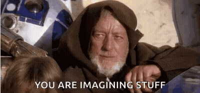 A Man With A Beard Is Sitting Next To A Robot . GIF