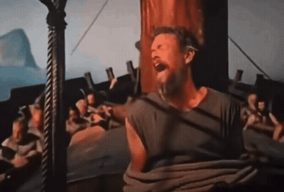 A Man With A Beard Is Sitting On A Boat And Screaming GIF