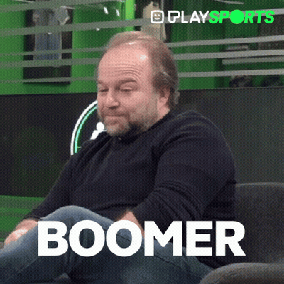 A Man With A Beard Is Sitting On A Couch With The Word Boomer Written On The Bottom GIF
