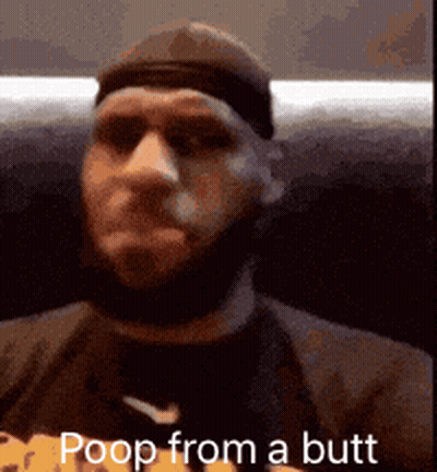A Man With A Beard Is Sitting On A Couch With The Words Poop From A Butt Written On The Screen . GIF