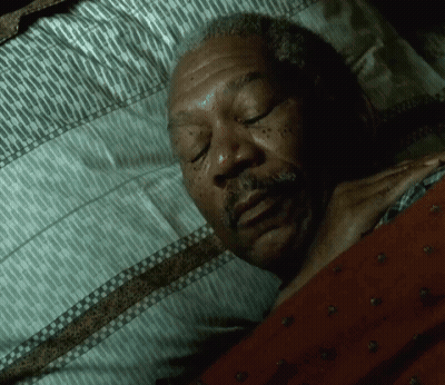 A Man With A Beard Is Sleeping In A Bed GIF