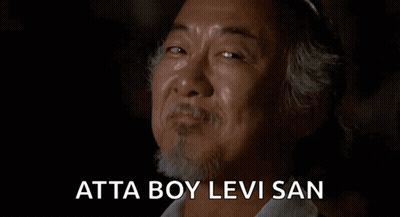 A Man With A Beard Is Smiling And Crying With The Words Atta Boy Levi San Written Below Him . GIF