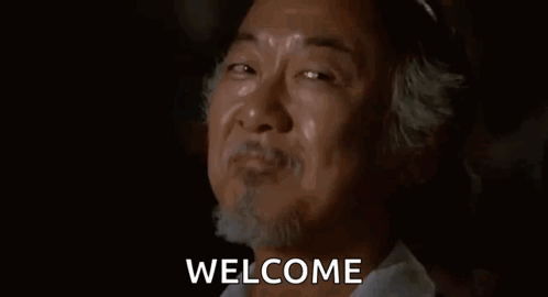 A Man With A Beard Is Smiling And Crying With The Words Welcome Behind Him . GIF