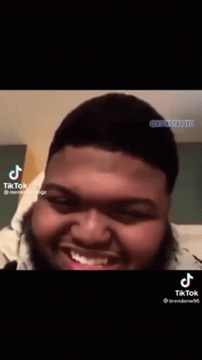 A Man With A Beard Is Smiling And Making A Funny Face On A Tiktok Video . GIF