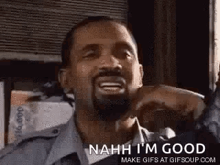 A Man With A Beard Is Smiling And Making A Funny Face . GIF