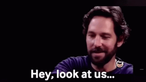 A Man With A Beard Is Smiling And Saying Hey , Look At Us . GIF