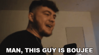 A Man With A Beard Is Smiling And Says Man , This Guy Is Boujee . GIF