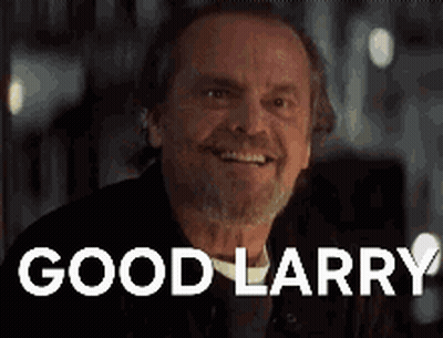 A Man With A Beard Is Smiling And The Words `` Good Larry '' Are On The Screen Behind Him . GIF