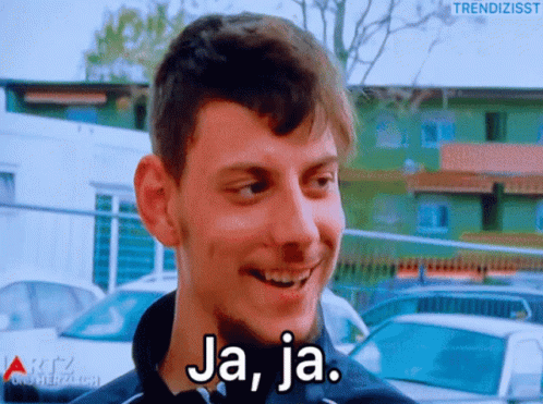 A Man With A Beard Is Smiling And The Words Ja Ja Are On His Face GIF