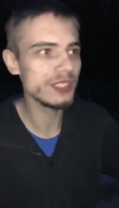 A Man With A Beard Is Smiling And Wearing A Blue Shirt . GIF