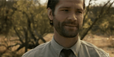 A Man With A Beard Is Smiling And Wearing A Shirt That Says Fox GIF