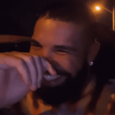 A Man With A Beard Is Smiling And Wearing A Shirt That Says ' Paris ' On It GIF