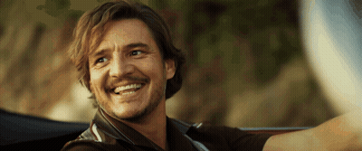 A Man With A Beard Is Smiling While Driving A Car GIF