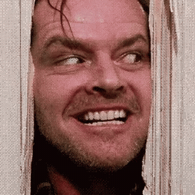 A Man With A Beard Is Smiling While Looking Out Of A Doorway . GIF