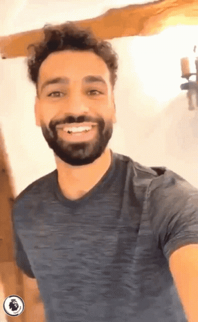 A Man With A Beard Is Smiling While Wearing A Blue Shirt GIF