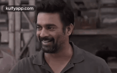 A Man With A Beard Is Smiling With His Eyes Closed In A Black And White Photo . GIF