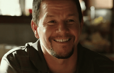 A Man With A Beard Is Smiling With His Teeth Visible GIF