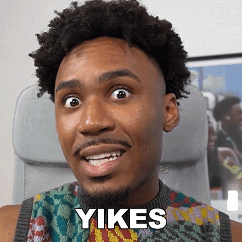 A Man With A Beard Is Smiling With The Word Yikes On His Face GIF