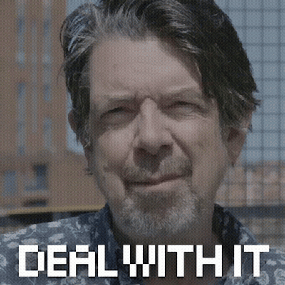 A Man With A Beard Is Smiling With The Words Deal With It Behind Him GIF