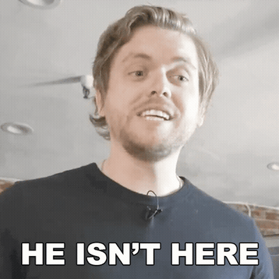 A Man With A Beard Is Smiling With The Words He Is N't Here Below Him GIF