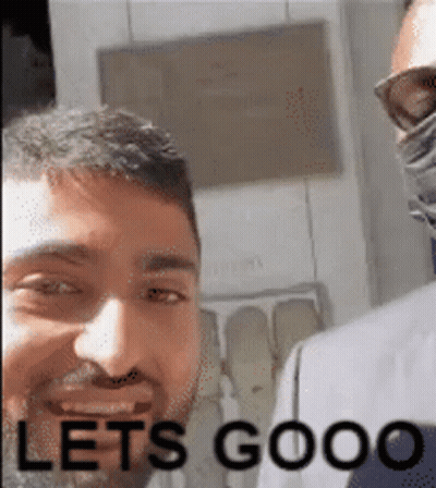 A Man With A Beard Is Smiling With The Words Let 'S Goooo Written Below Him . GIF