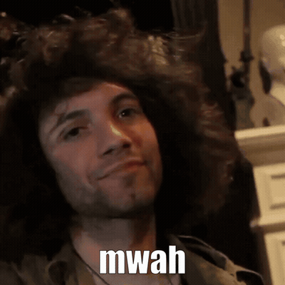 A Man With A Beard Is Smiling With The Words Mwah Written On His Face GIF