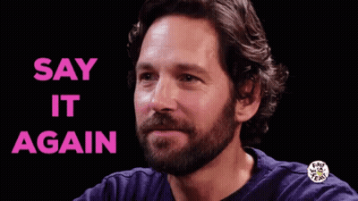 A Man With A Beard Is Smiling With The Words `` Say It Again '' Written Above Him . GIF