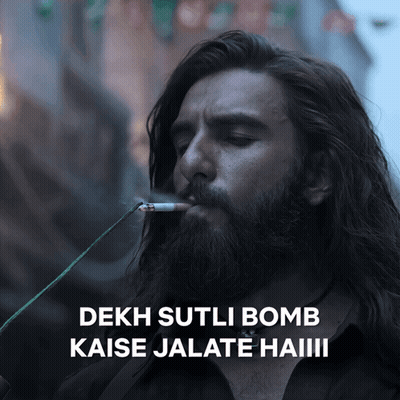 A Man With A Beard Is Smoking A Cigarette And Says " Dekh Sutli Bomb " GIF