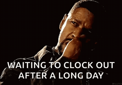 A Man With A Beard Is Smoking A Cigarette In The Dark . GIF