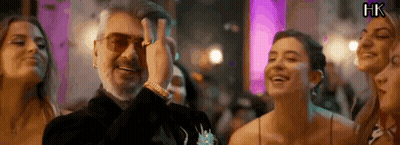 A Man With A Beard Is Standing In A Crowd Of People . GIF