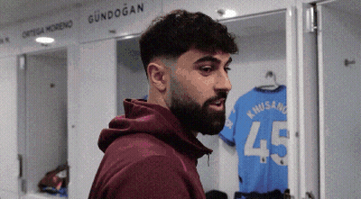 A Man With A Beard Is Standing In A Locker Room With A Shirt That Says 45 On It GIF