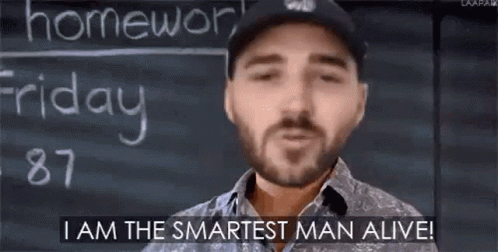 A Man With A Beard Is Standing In Front Of A Blackboard And Saying `` I Am The Smartest Man Alive ! '' GIF