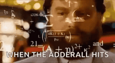 A Man With A Beard Is Standing In Front Of A Chalkboard With Mathematical Equations . GIF