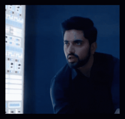 A Man With A Beard Is Standing In Front Of A Computer Screen That Says ' A ' On It GIF