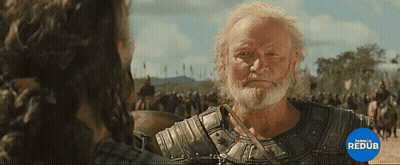 A Man With A Beard Is Standing In Front Of A Crowd And A Blue Circle That Says Parello Redub GIF