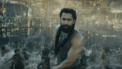 A Man With A Beard Is Standing In Front Of A Crowd Of People And A Watermark That Says Nanparaarmy GIF