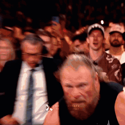A Man With A Beard Is Standing In Front Of A Crowd With The Word Atorfx On The Bottom Right Corner GIF