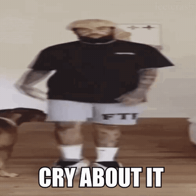 A Man With A Beard Is Standing In Front Of A Dog And Says `` Cry About It '' While Dancing . GIF