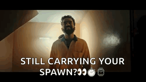 A Man With A Beard Is Standing In Front Of A Door And Says Still Carrying Your Spawn GIF