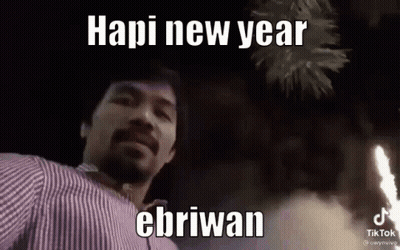 A Man With A Beard Is Standing In Front Of A Fireworks Display And Says Hapi New Year Ebriwan . GIF